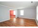 Bright living room with gleaming hardwood floors, neutral wall color and an archway to the adjacent room at 66 Johnstone Ln., Georgetown, SC 29440