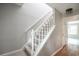 Carpeted staircase with white railings and a view to a bright living space at 66 Johnstone Ln., Georgetown, SC 29440