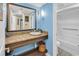 Bathroom featuring blue walls, stylish vanity with granite countertop and white sink at 6900 N Ocean Blvd. # 1541, Myrtle Beach, SC 29572