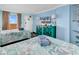 Light blue bedroom features a large TV, decorative cabinet, ocean-themed decor, and two beds with bedding at 6900 N Ocean Blvd. # 1541, Myrtle Beach, SC 29572