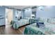 Light blue bedroom featuring two beds with ocean-themed bedding, closet with mirror doors, and hardwood floor at 6900 N Ocean Blvd. # 1541, Myrtle Beach, SC 29572
