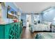 Light blue bedroom features a large TV, decorative cabinet, ocean-themed decor, and two beds with bedding at 6900 N Ocean Blvd. # 1541, Myrtle Beach, SC 29572