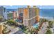 Beautiful oceanfront condo building with pools, palm trees, and balconies overlooking the beach at 6900 N Ocean Blvd. # 1541, Myrtle Beach, SC 29572