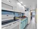 Bright kitchen featuring white and light blue cabinets, modern appliances, and a view of the ocean at 6900 N Ocean Blvd. # 1541, Myrtle Beach, SC 29572