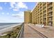 Expansive oceanfront balcony furnished with lounge chairs, perfect for enjoying breathtaking views of the beach and ocean at 6900 N Ocean Blvd. # 1541, Myrtle Beach, SC 29572