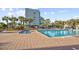 Inviting pool area with lush palm trees, lounge chairs, and a view of the oceanfront resort at 6900 N Ocean Blvd. # 1541, Myrtle Beach, SC 29572