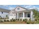 Charming two-story home featuring a covered entryway, attached garage, and professionally landscaped front yard at 719 Rupert Dr, Conway, SC 29526