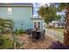 Backyard patio featuring brick pavers, a grill, and outdoor seating with palm trees at 721 Mckinley Way, Myrtle Beach, SC 29577