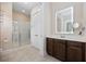 Bright bathroom with shower, storage cabinet, and stylish vanity mirror at 721 Mckinley Way, Myrtle Beach, SC 29577