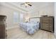 Light-filled bedroom with tray ceiling, coastal decor, and plantation shutters at 721 Mckinley Way, Myrtle Beach, SC 29577