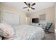 Bedroom showcasing a queen-size bed, ceiling fan, large closet, and cozy rocking chair at 721 Mckinley Way, Myrtle Beach, SC 29577