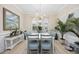 Bright dining room with modern chandelier, shuttered windows, and decor at 721 Mckinley Way, Myrtle Beach, SC 29577