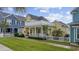Charming yellow two-story home featuring a porch and a second-story deck at 721 Mckinley Way, Myrtle Beach, SC 29577