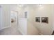 Bright hallway featuring carpet floors, neutral walls, and decorative wall art leading to multiple rooms at 721 Mckinley Way, Myrtle Beach, SC 29577