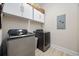 Well-equipped laundry room with modern washer, dryer, and storage cabinets at 721 Mckinley Way, Myrtle Beach, SC 29577