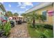Outdoor patio with brick pavers, palm trees, black chairs, and a grill at 721 Mckinley Way, Myrtle Beach, SC 29577