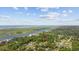 Expansive aerial view of home with waterfront access, lush green surroundings, and scenic coastal backdrop at 7288 Schooners Ct. Sw, Ocean Isle Beach, NC 28469