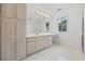 Bright bathroom featuring ample counter space, storage cabinets and a window with outside view at 7288 Schooners Ct. Sw, Ocean Isle Beach, NC 28469