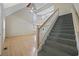 Open entryway with hardwood floors, a staircase, and a view of the kitchen on the lower level at 7288 Schooners Ct. Sw, Ocean Isle Beach, NC 28469
