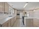 Functional kitchen featuring a central island with an oven and a classic tile backsplash and countertops at 7288 Schooners Ct. Sw, Ocean Isle Beach, NC 28469