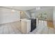 The kitchen features a central island with countertops, an adjoining dining area, and hardwood flooring at 7288 Schooners Ct. Sw, Ocean Isle Beach, NC 28469
