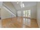 Bright living room features vaulted ceilings, staircase, and large windows filling the space with natural light at 7288 Schooners Ct. Sw, Ocean Isle Beach, NC 28469