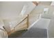 View looking down a carpeted staircase into an entryway with hardwood flooring and a front door at 7288 Schooners Ct. Sw, Ocean Isle Beach, NC 28469