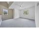 Carpeted upstairs room with a ceiling fan and two windows providing natural light, and neutral colored walls at 7288 Schooners Ct. Sw, Ocean Isle Beach, NC 28469