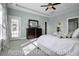 Main bedroom featuring a king bed, ceiling fan, light blue walls, and a glass door leading outside at 872 Fowler Rd., Conway, SC 29526