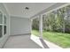 Relaxing covered patio showcasing a view of the grassy lawn and bordering trees at 872 Fowler Rd., Conway, SC 29526