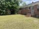 Backyard featuring a shed and the brick exterior of the home with an entrance at 911 Park Ave., Marion, SC 29571