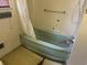 This full bathroom has a green bathtub with a shower curtain and is ready for renovation at 911 Park Ave., Marion, SC 29571