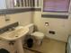 A full bathroom featuring a pedestal sink, toilet, and wallpapered accents at 911 Park Ave., Marion, SC 29571