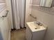 A full bathroom featuring a single sink vanity and a shower with a white shower curtain at 911 Park Ave., Marion, SC 29571