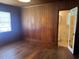 Bedroom featuring wood paneling, hardwood floors, and an ensuite bathroom at 911 Park Ave., Marion, SC 29571