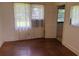Bright bedroom featuring hardwood floors and an open door to an ensuite bathroom at 911 Park Ave., Marion, SC 29571
