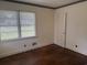 Vacant bedroom featuring hardwood floors, two windows with blinds, and a closet at 911 Park Ave., Marion, SC 29571