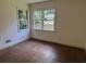 A vacant bedroom with hardwood floors and two windows providing ample natural light at 911 Park Ave., Marion, SC 29571