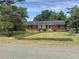 Charming single story brick home with well-maintained front yard and mature trees at 911 Park Ave., Marion, SC 29571