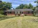 Charming brick home featuring a well-maintained lawn and classic design elements at 911 Park Ave., Marion, SC 29571