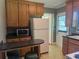 Kitchen features a breakfast bar, a refrigerator, and cabinets with dark countertops at 911 Park Ave., Marion, SC 29571