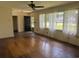 Bright living room with hardwood floors, a black front door, and large windows at 911 Park Ave., Marion, SC 29571