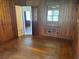 Living room featuring hardwood floors, wood paneling, and doorways to other rooms at 911 Park Ave., Marion, SC 29571