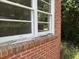 Close up of the exterior of the brick home highlighting a window with a white frame at 911 Park Ave., Marion, SC 29571