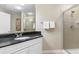 Bathroom features granite countertop, white cabinets, and a shower with glass doors at 9994 Beach Club Dr. # 1202, Myrtle Beach, SC 29572