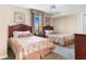 Inviting bedroom featuring two beds, ceiling fan, and framed prints at 9994 Beach Club Dr. # 1202, Myrtle Beach, SC 29572