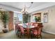 A dining room features a table with seating for eight, a chandelier, and tasteful décor at 9994 Beach Club Dr. # 1202, Myrtle Beach, SC 29572