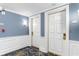 Hallway featuring neutral walls, white trim, stylish carpet, and two white doors with gold hardware at 9994 Beach Club Dr. # 1202, Myrtle Beach, SC 29572