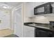 Kitchenette area featuring a sink, microwave, and mini-refrigerator with cabinets, ready for snacks at 9994 Beach Club Dr. # 1202, Myrtle Beach, SC 29572