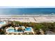 Oceanfront resort with a vibrant pool area, palm trees and beach access at 9994 Beach Club Dr. # 1202, Myrtle Beach, SC 29572